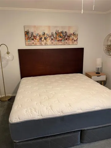 a bed sitting in a bedroom with wooden floor