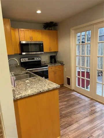 a kitchen with stainless steel appliances granite countertop a sink stove and cabinets