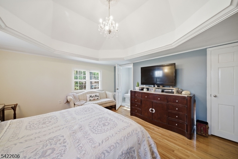 399 Springbrook Trail Sparta, NJ 07871 - Photo 7 of 27 a bedroom with a bed and a flat screen tv