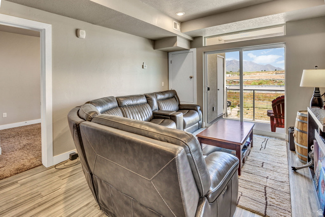 2101 North Main Street, Unit 306 Sunset, UT 84015 - Photo 8 of 22 Living area featuring wood-finish flooring and a sliding glass door