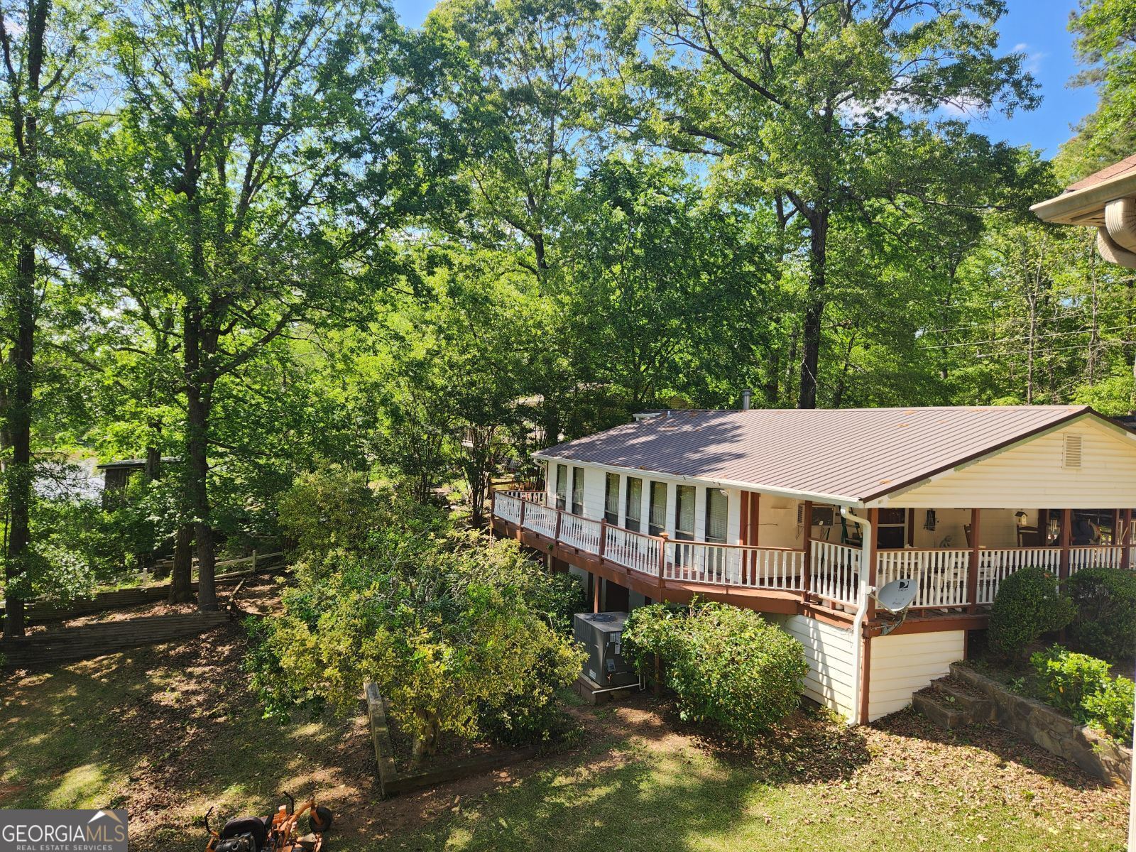 a view of a house with yard and sitting area