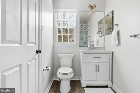 a bathroom with a toilet sink and a mirror
