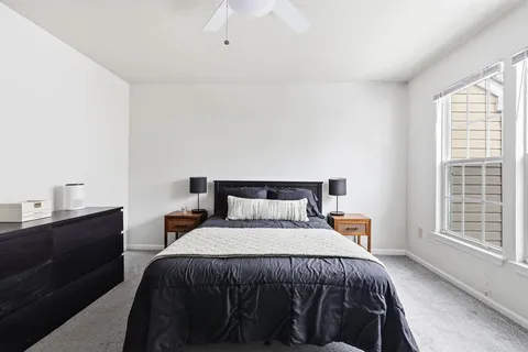 a bedroom with a bed and window