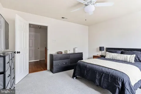 a bedroom with bed and a ceiling fan