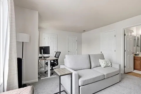 a living room with furniture and a lamp