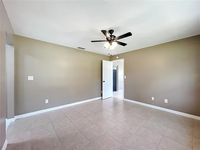 a view of an empty room with a fan