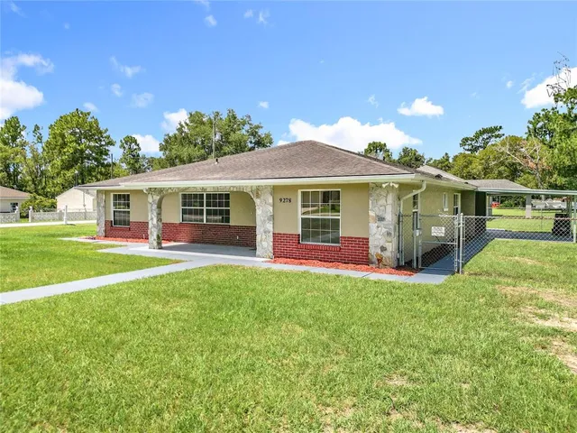 a front view of house with yard and trees