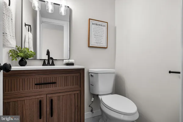 a bathroom with a toilet a sink and a mirror
