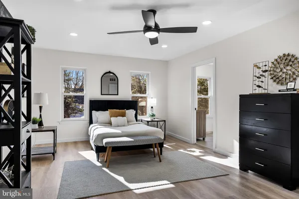 a living room with furniture and a ceiling fan