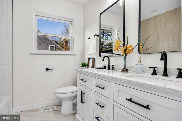 a bathroom with a toilet a sink and mirror