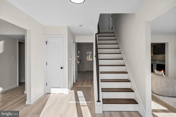 a view of entryway with wooden floor and windows