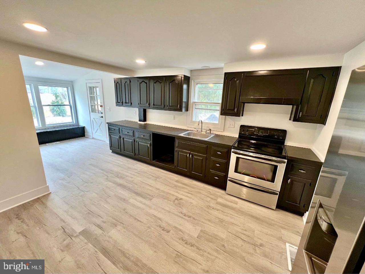 3358 Bargaintown Road Egg Harbor Township, NJ 08234 - Photo 4 of 8 a kitchen with stainless steel appliances kitchen island granite countertop a stove a sink and a refrigerator