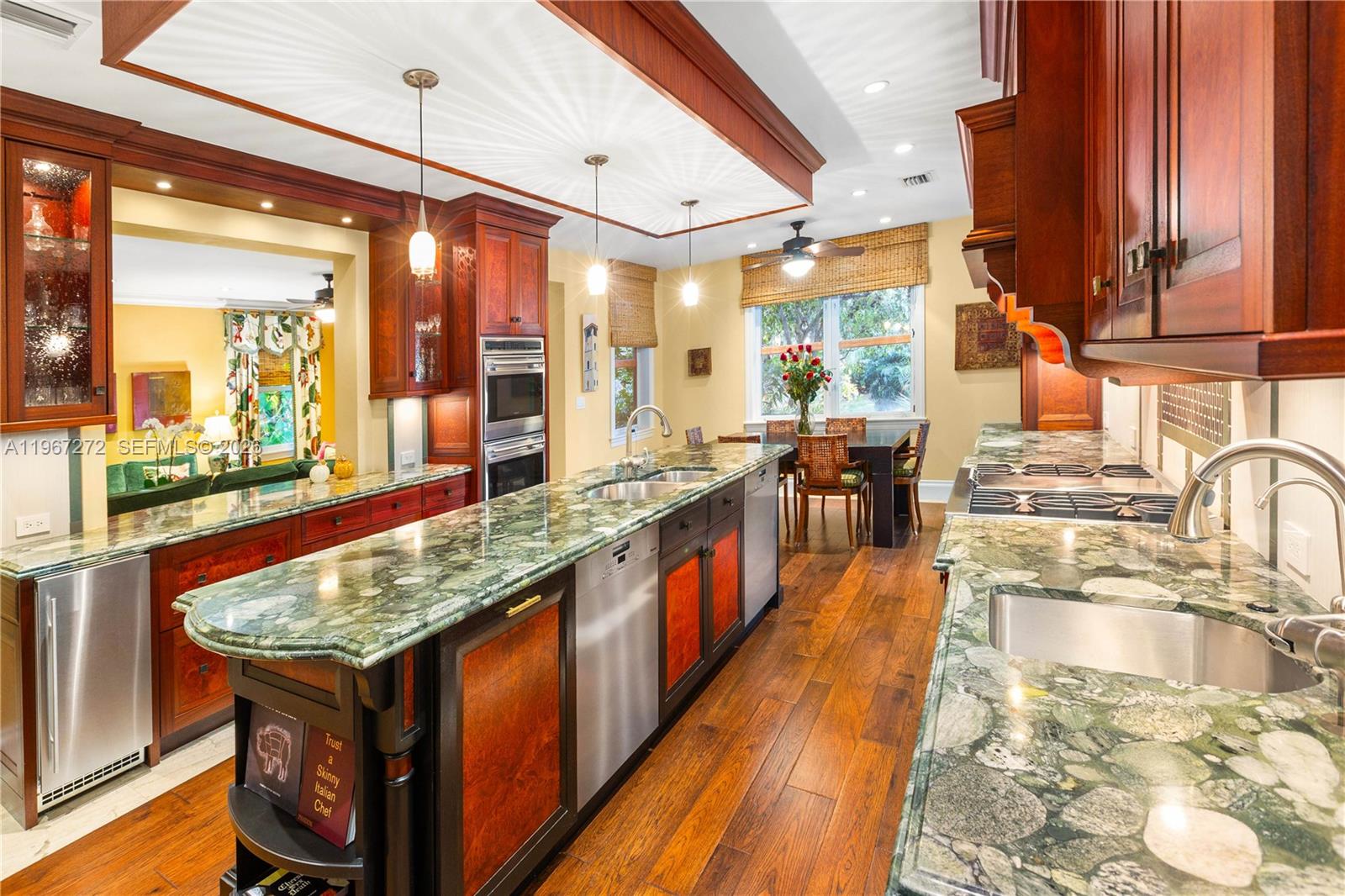 4867 Southwest 82nd Street Miami, FL 33143 - Photo 33 of 69 a kitchen with stainless steel appliances granite countertop a stove a sink and a wooden cabinets
