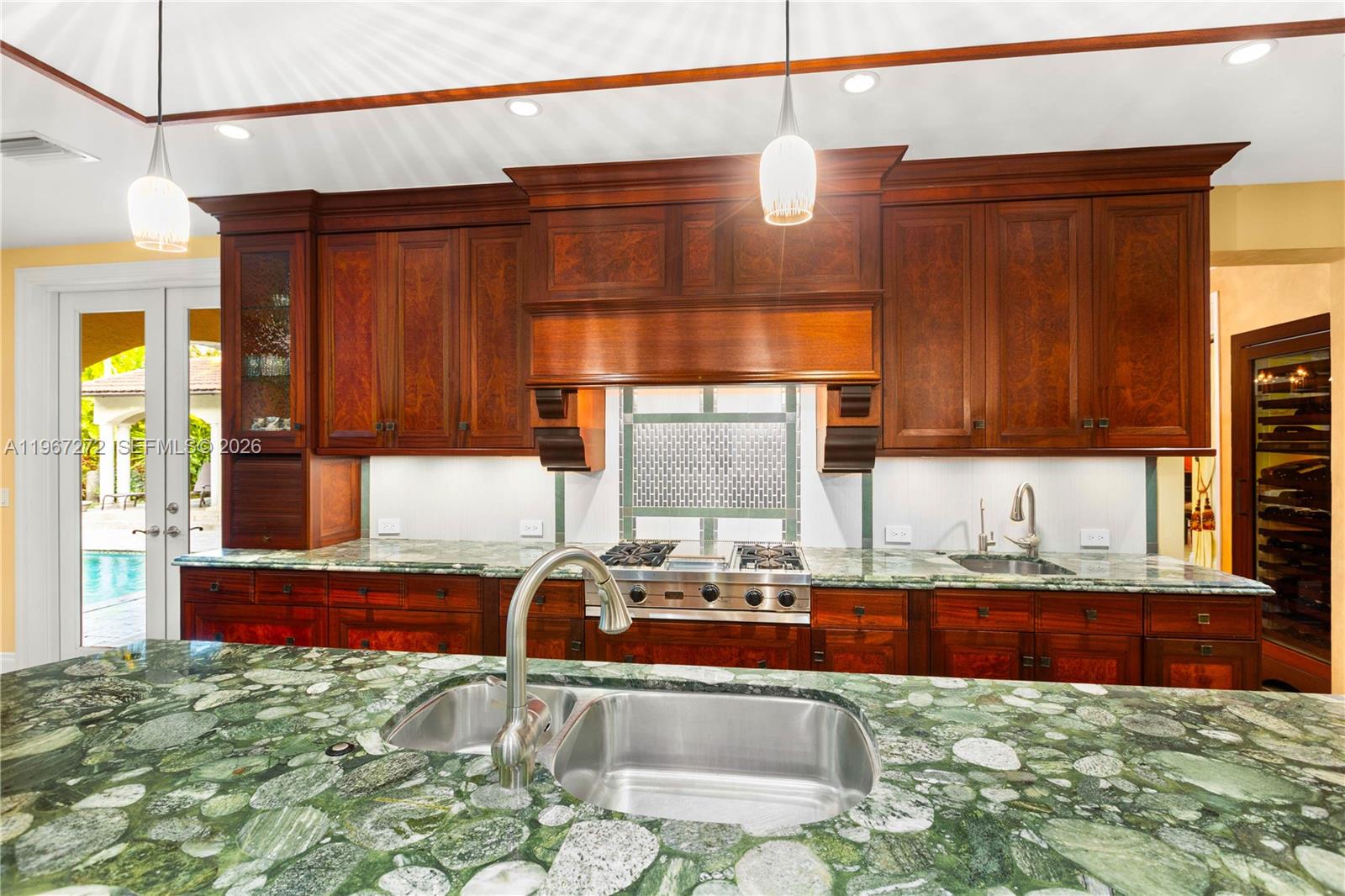 4867 Southwest 82nd Street Miami, FL 33143 - Photo 35 of 69 a kitchen with granite countertop a sink and a counter top space