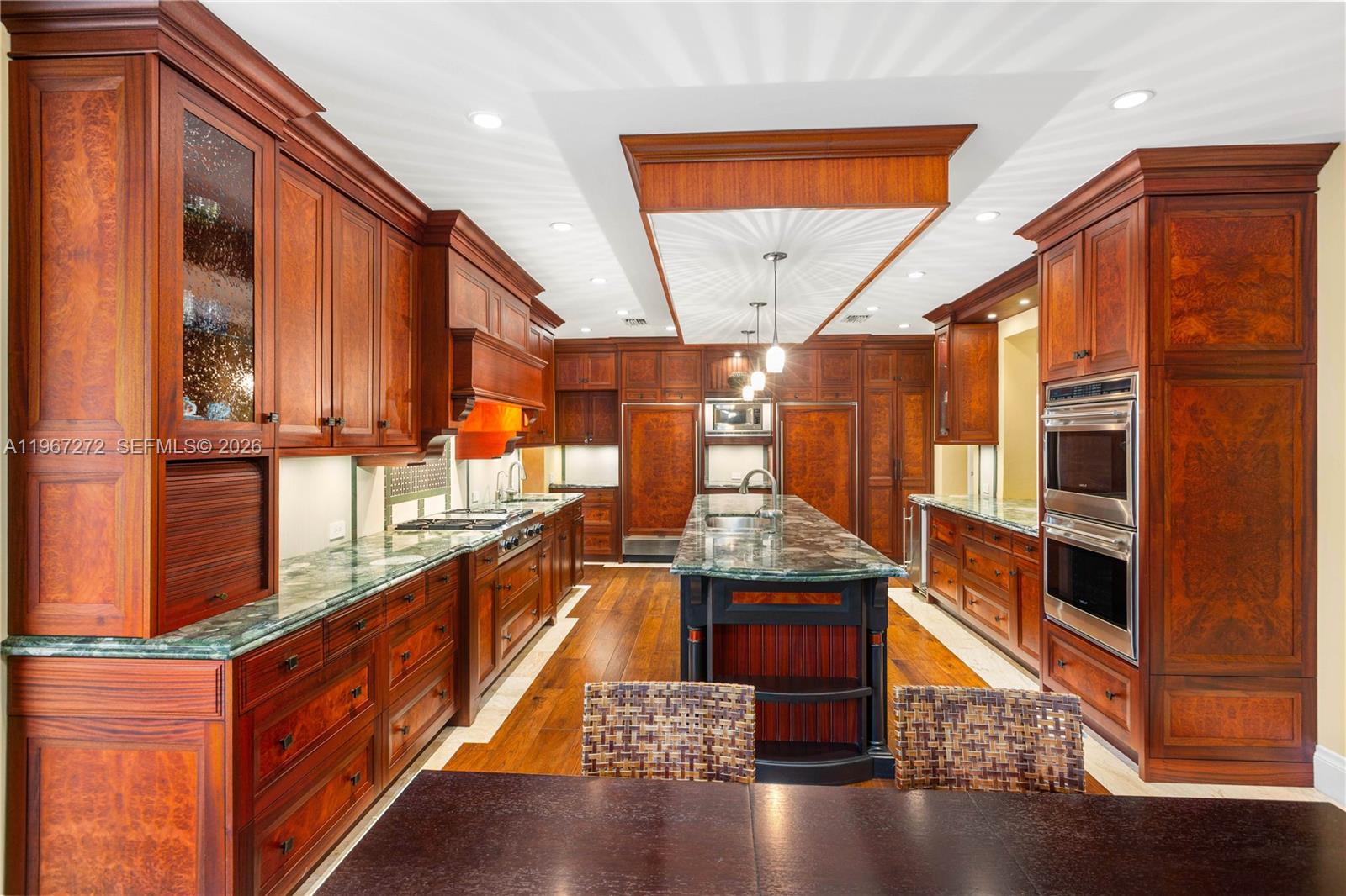 4867 Southwest 82nd Street Miami, FL 33143 - Photo 37 of 69 a kitchen with stainless steel appliances granite countertop a stove and a wooden floors