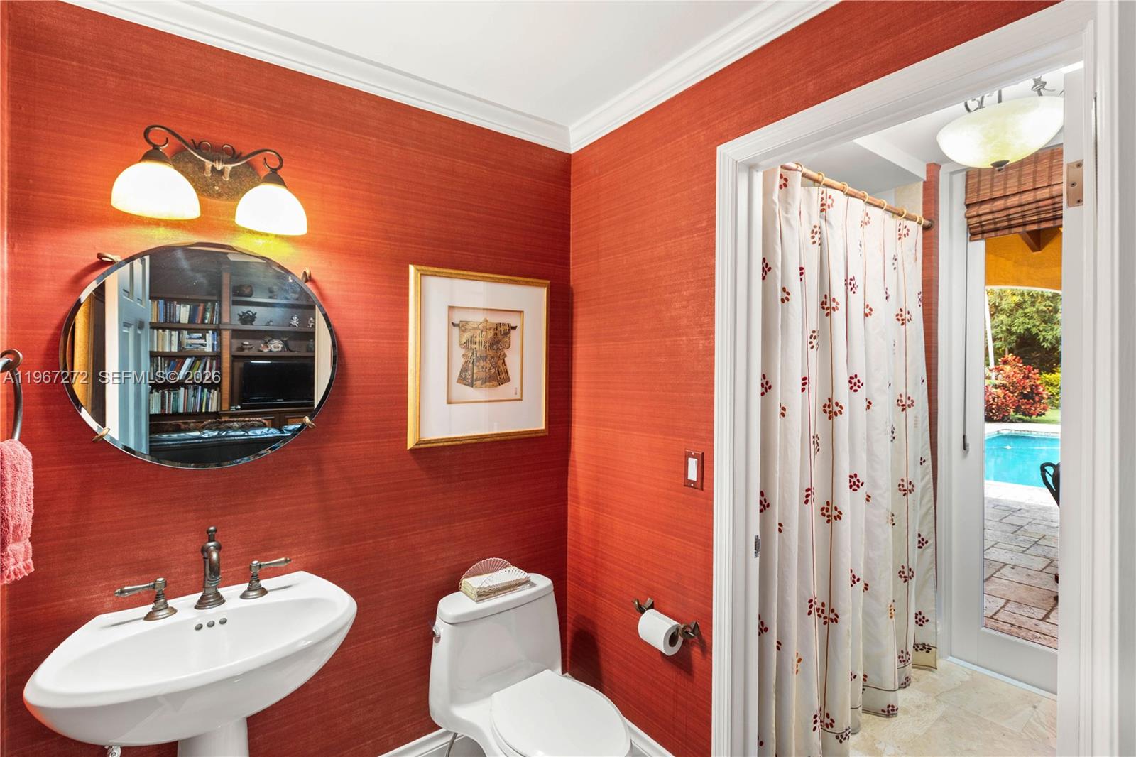 4867 Southwest 82nd Street Miami, FL 33143 - Photo 43 of 69 a bathroom with a toilet sink and mirror