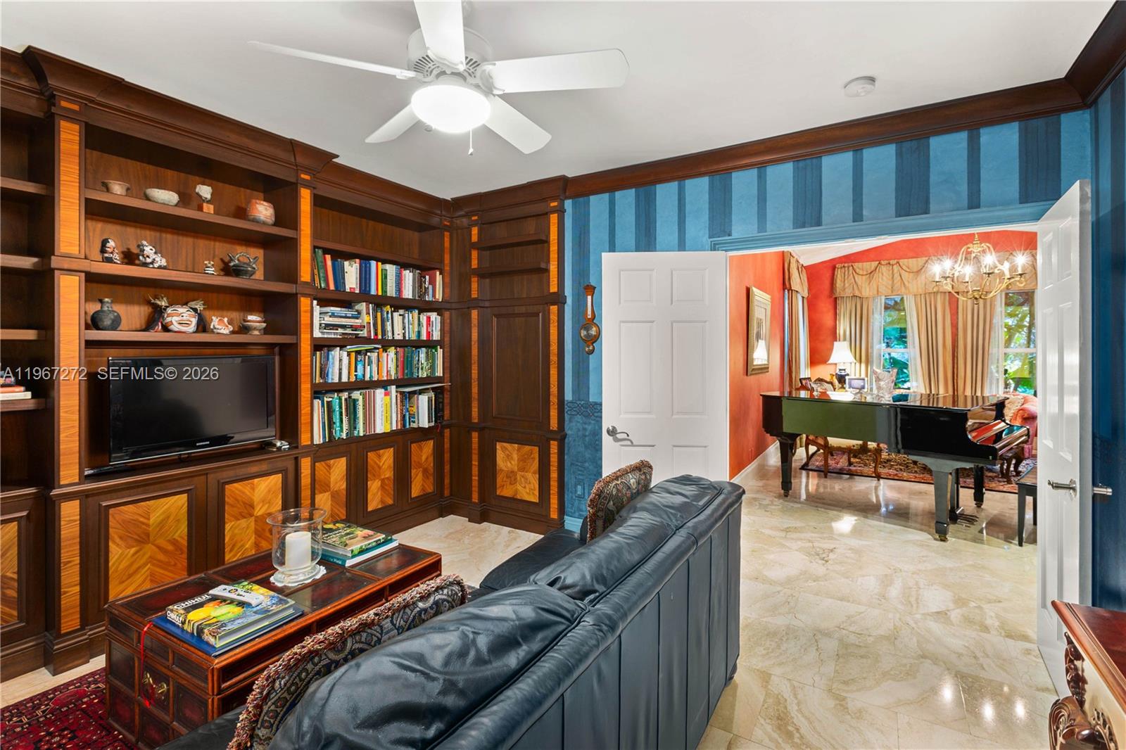 4867 Southwest 82nd Street Miami, FL 33143 - Photo 45 of 69 a living room with furniture a flat screen tv and a floor to ceiling window