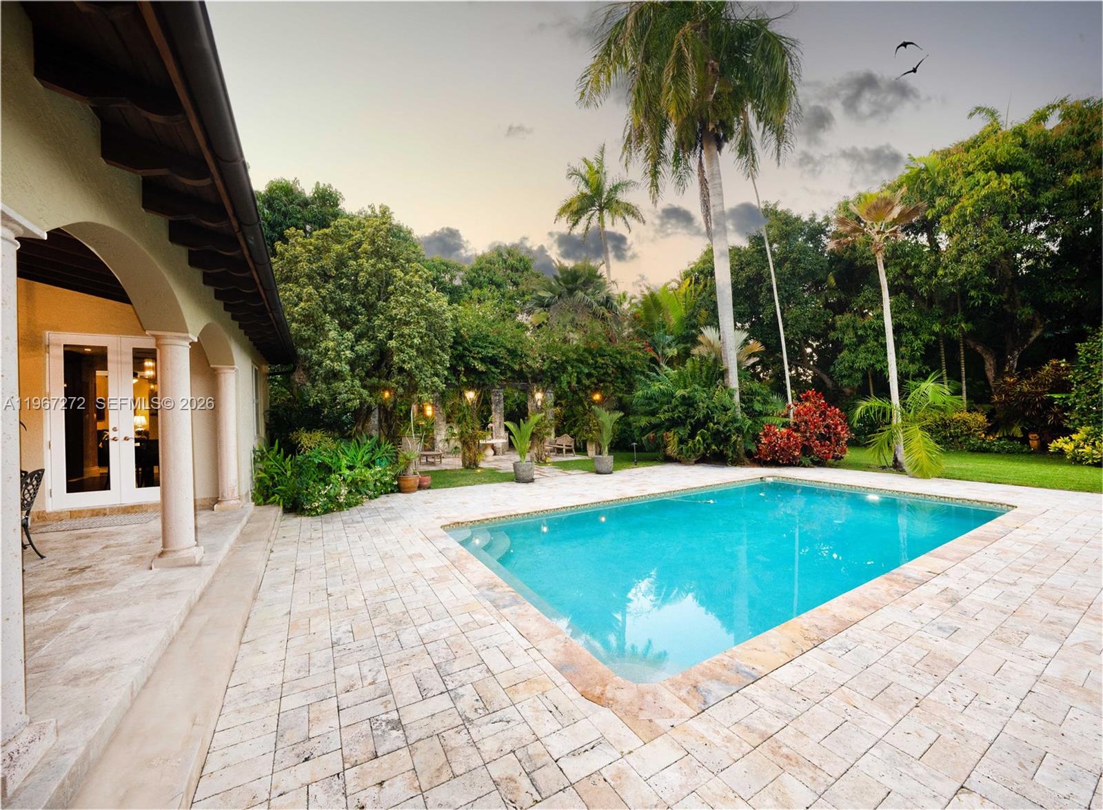 4867 Southwest 82nd Street Miami, FL 33143 - Photo 7 of 69 a view of a swimming pool with a yard and palm trees