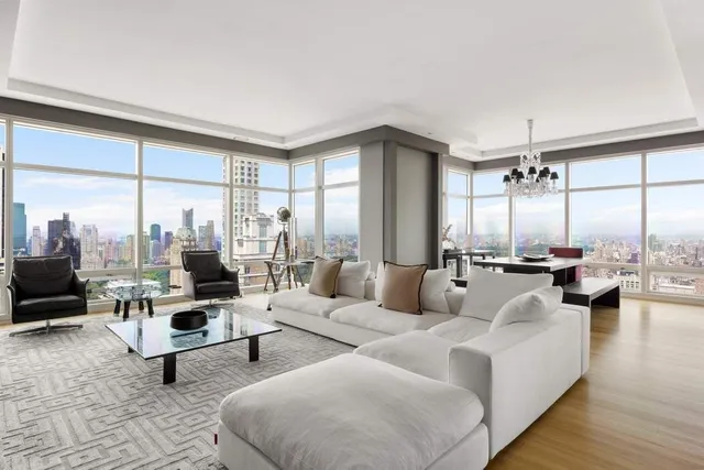 a living room with furniture and large windows