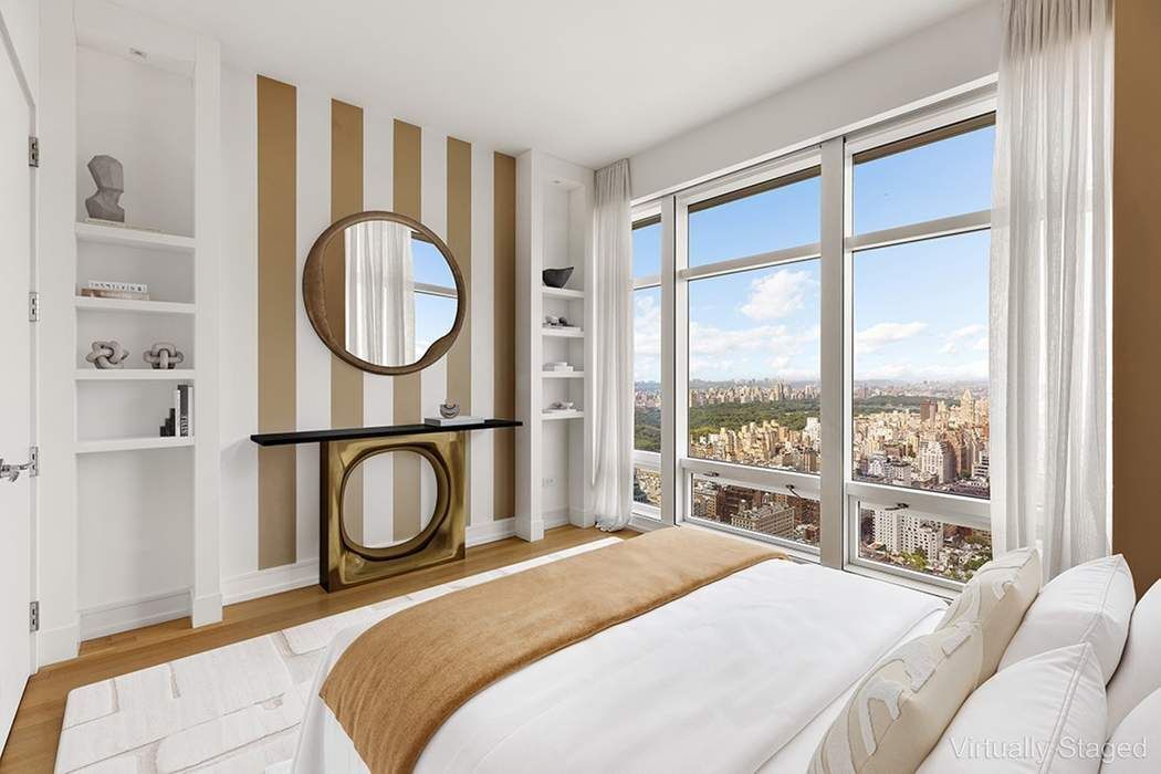 151 East 58th Street, Unit 35A Manhattan, NY 10022 - Photo 10 of 18 a bedroom with a bed a closet and a large window