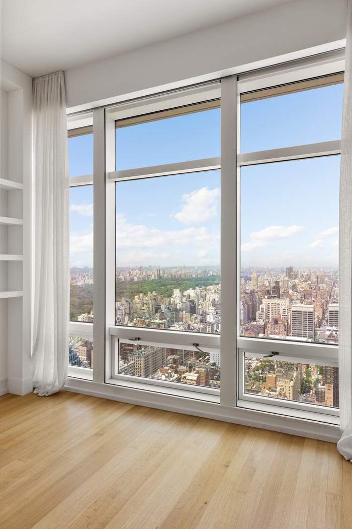 151 East 58th Street, Unit 35A Manhattan, NY 10022 - Photo 11 of 18 a view of a room with wooden floor and walls