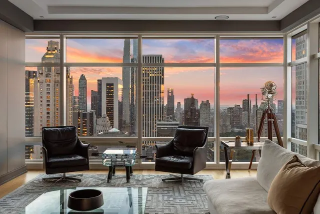 a living room with furniture tv and a large window