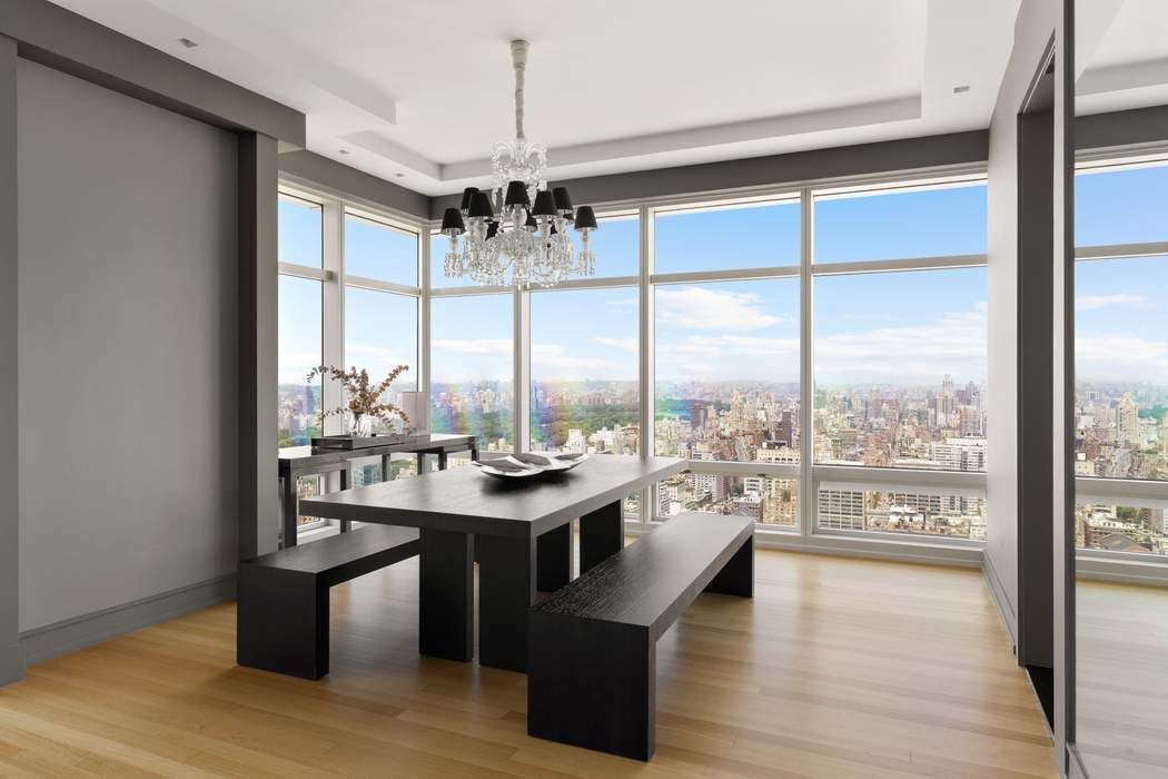 151 East 58th Street, Unit 35A Manhattan, NY 10022 - Photo 3 of 18 a view of a dining room with furniture window and wooden floor
