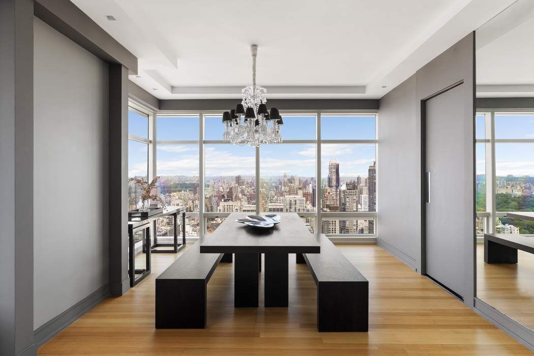 151 East 58th Street, Unit 35A Manhattan, NY 10022 - Photo 4 of 18 a view of a dining room with furniture large windows and wooden floor