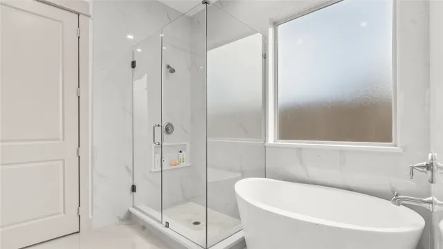 a bathroom with a tub a shower and a sink