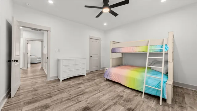 a bedroom with bed and a wooden floor