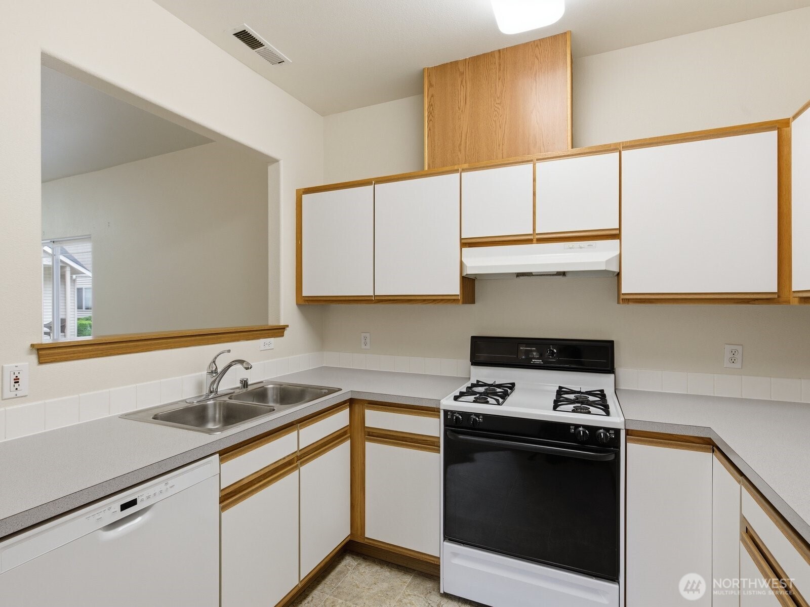 323 North Laventure Road, Unit C Mount Vernon, WA 98273 - Photo 10 of 24 a kitchen with stainless steel appliances granite countertop a sink a stove and a microwave