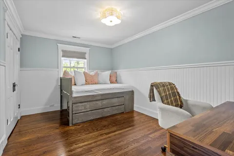 a bedroom with furniture and wooden floor
