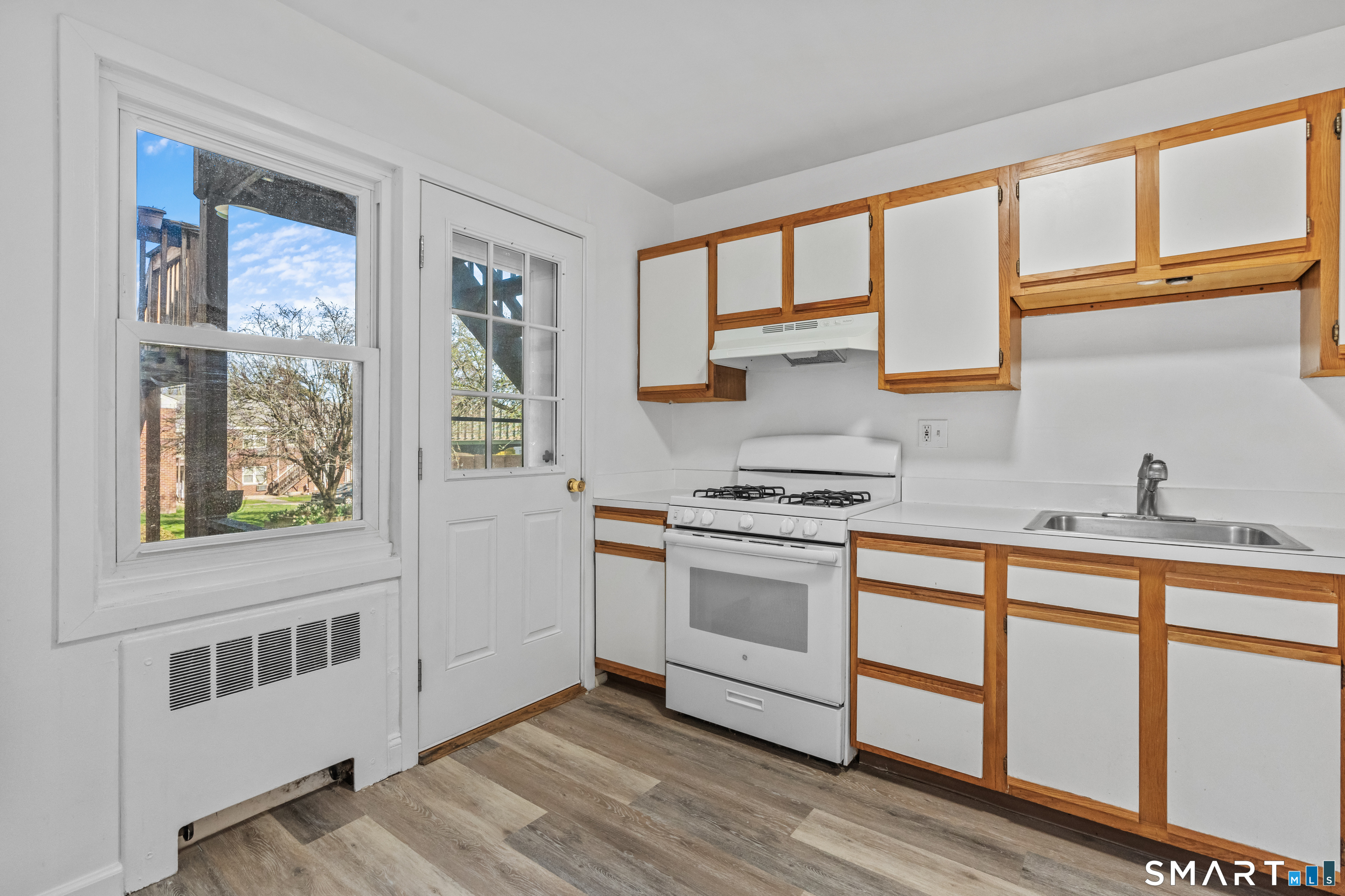 146 Blachley Road, Unit C Stamford, CT 06902 - Photo 12 of 44 a kitchen with stainless steel appliances granite countertop a stove a sink and a microwave