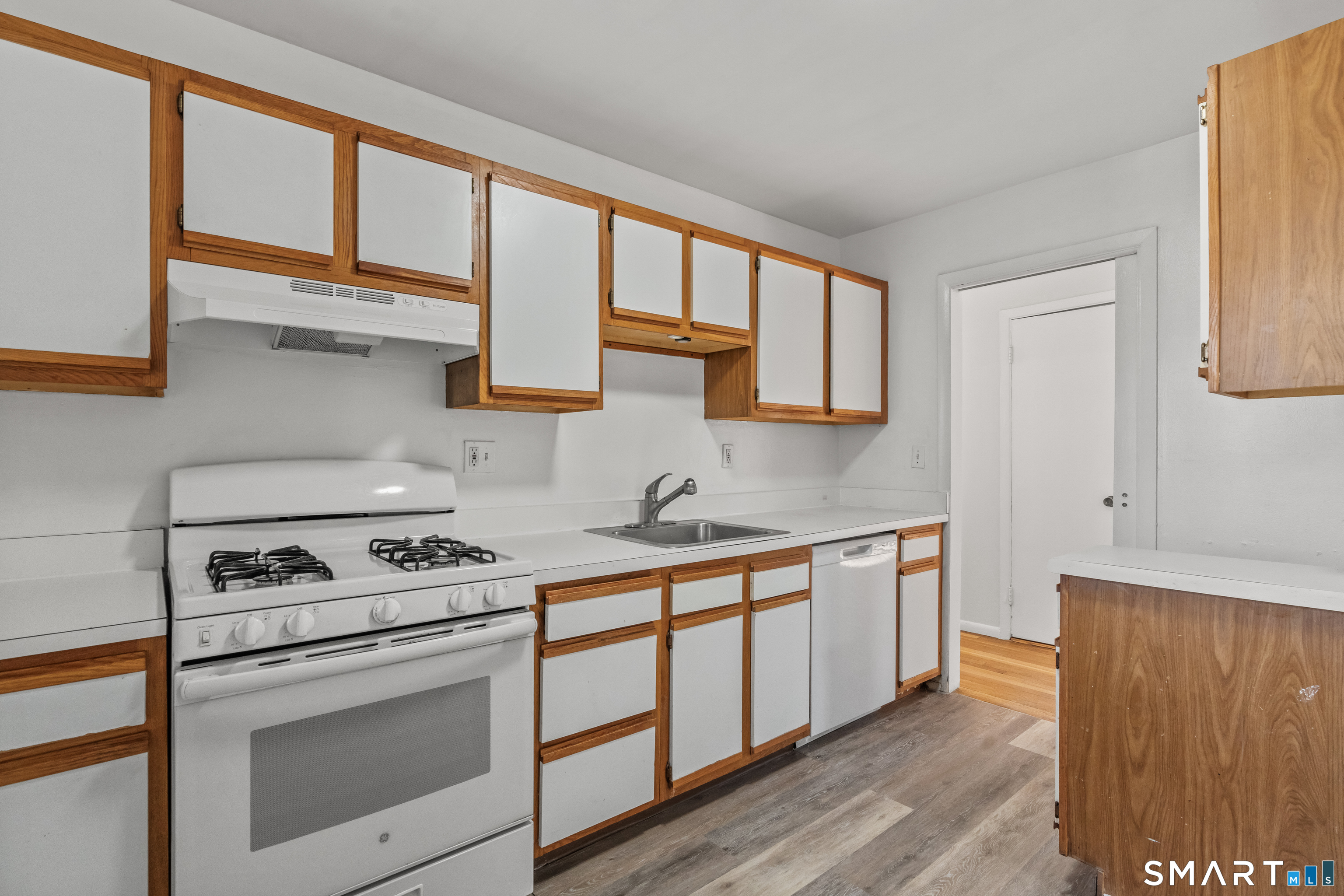 146 Blachley Road, Unit C Stamford, CT 06902 - Photo 14 of 44 a kitchen with stainless steel appliances a stove sink and cabinets