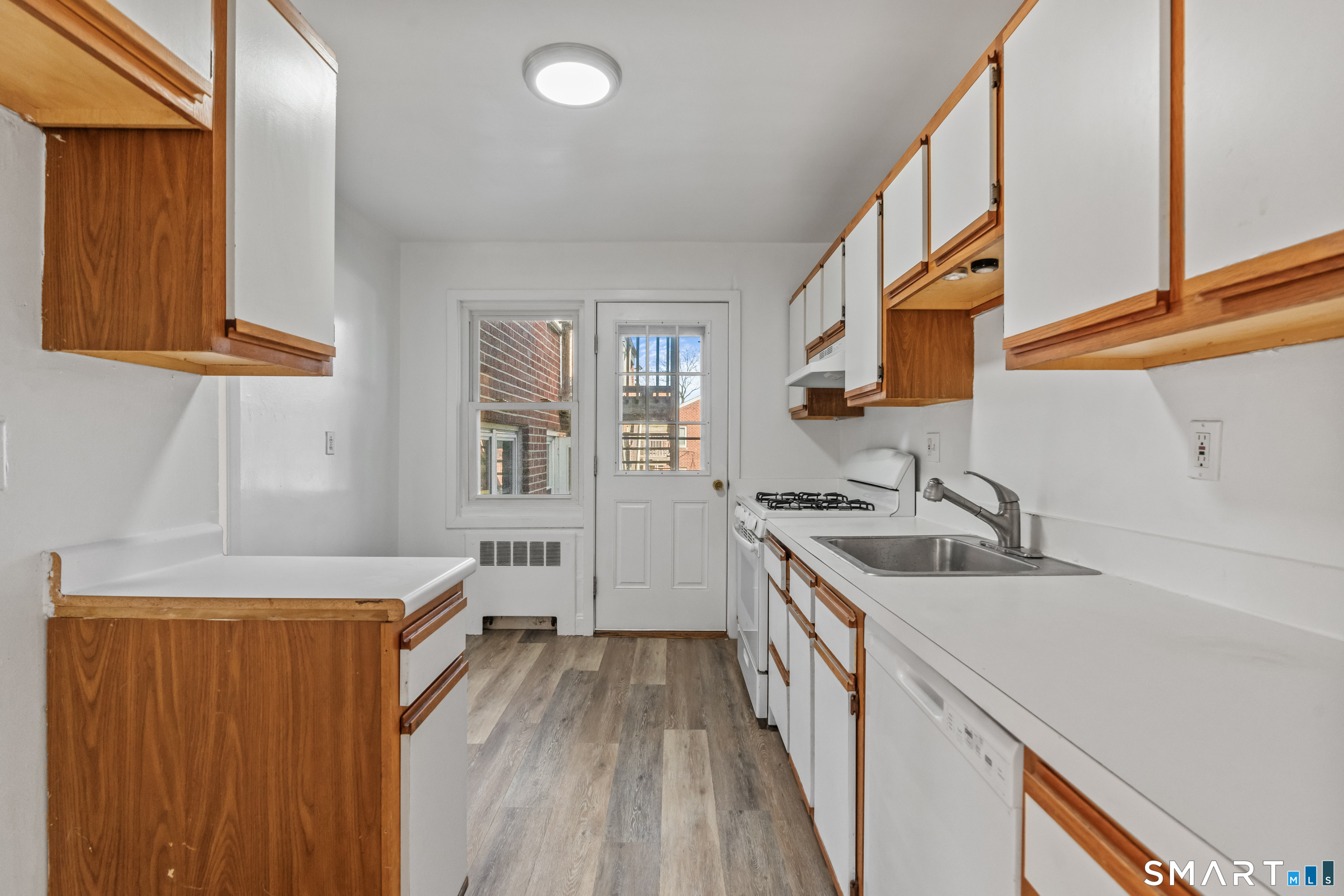 146 Blachley Road, Unit C Stamford, CT 06902 - Photo 16 of 44 a kitchen with a sink a stove and a refrigerator