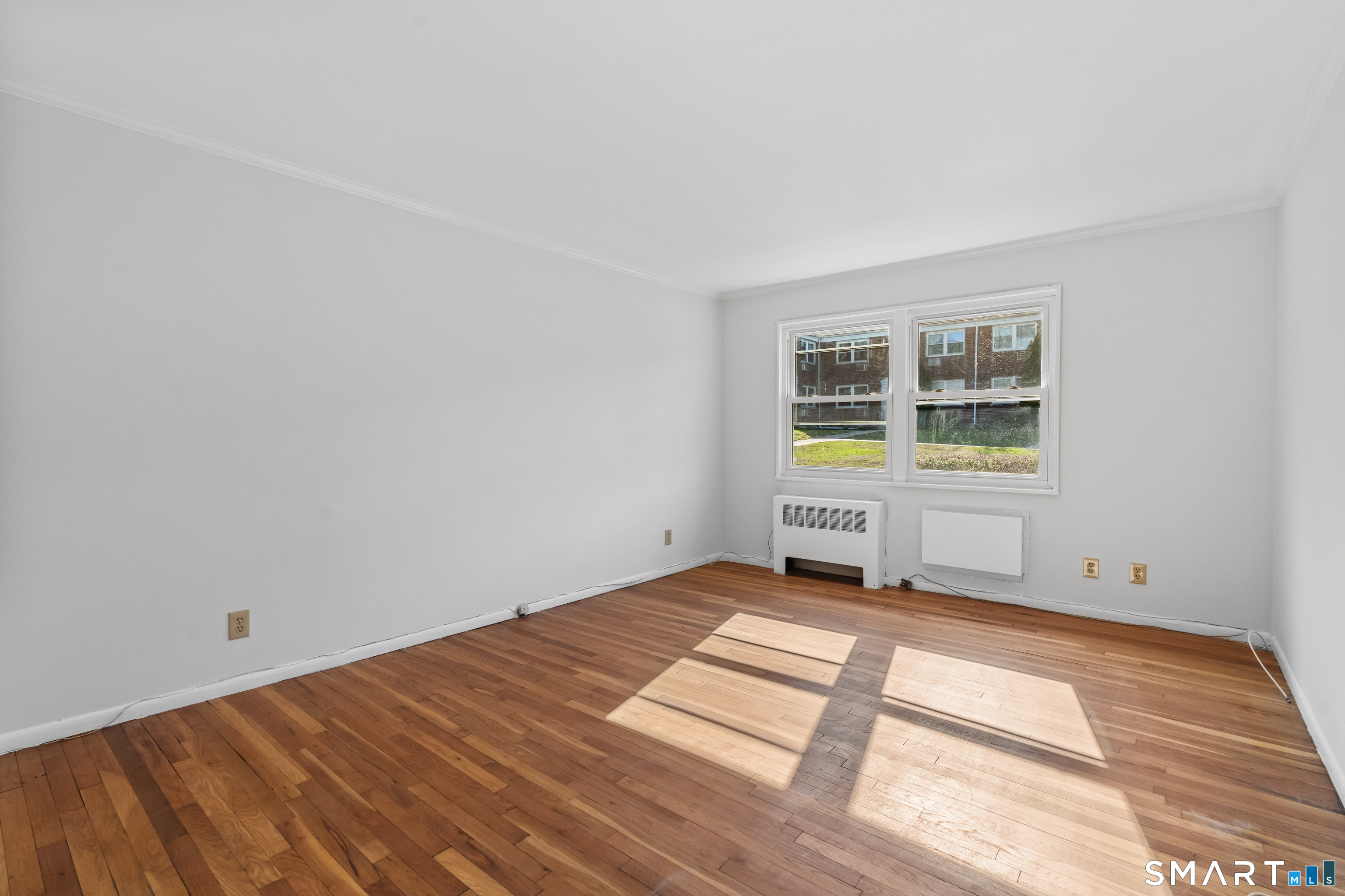 146 Blachley Road, Unit C Stamford, CT 06902 - Photo 20 of 44 a bedroom with a bed and a window