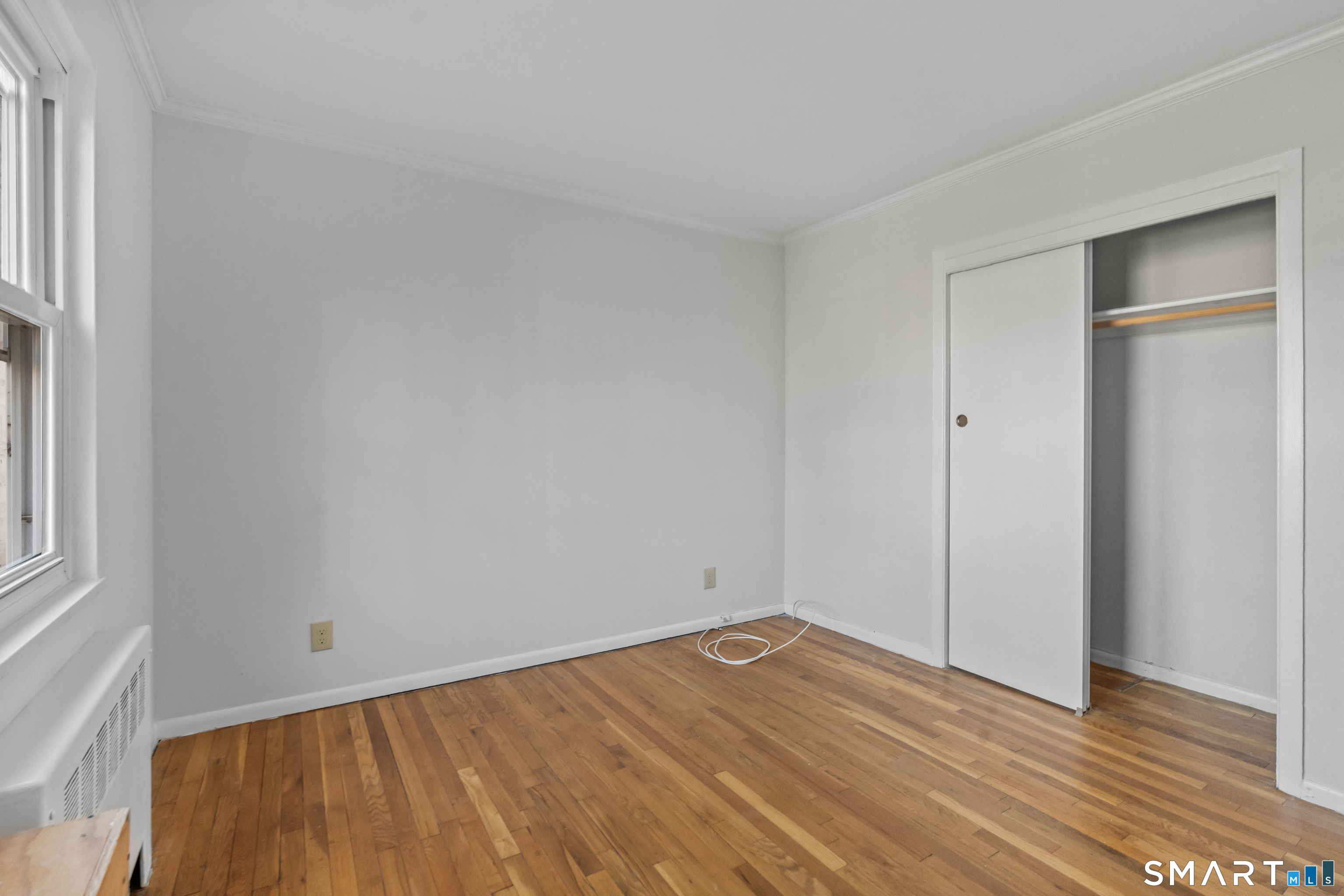 146 Blachley Road, Unit C Stamford, CT 06902 - Photo 26 of 44 a view of empty room with wooden floor and fan