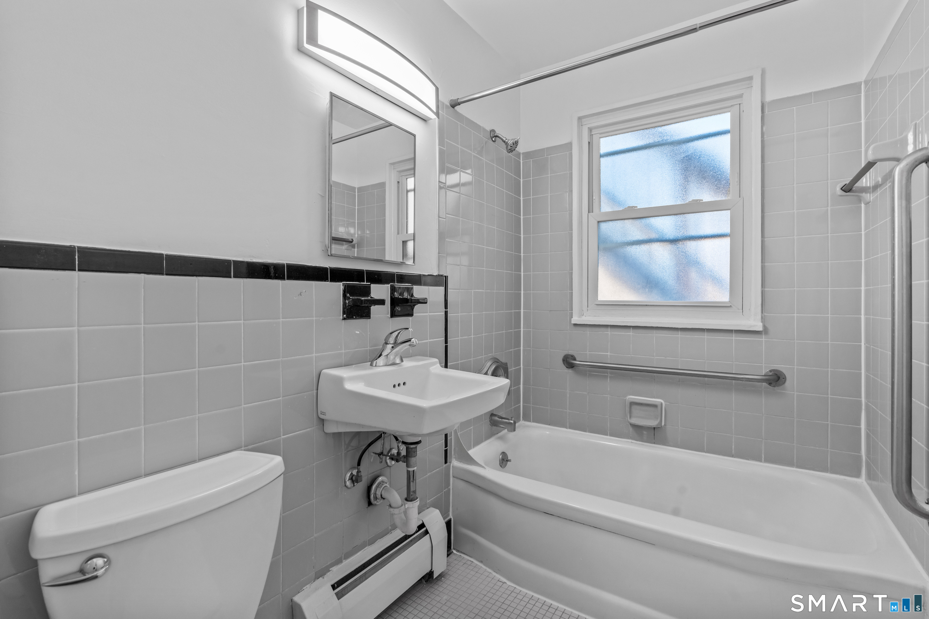 146 Blachley Road, Unit C Stamford, CT 06902 - Photo 27 of 44 a bathroom with a sink a toilet and shower