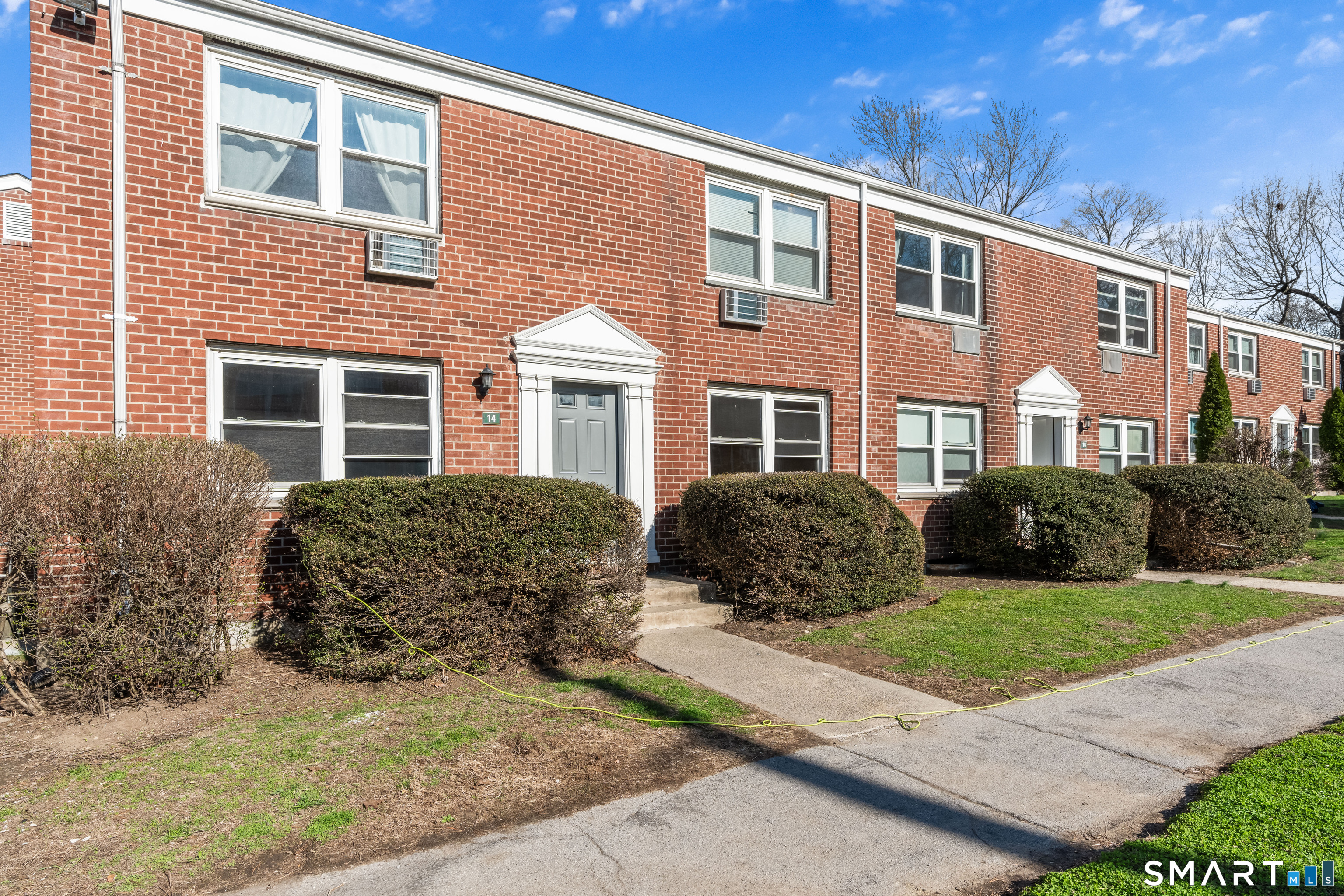 146 Blachley Road, Unit C Stamford, CT 06902 - Photo 29 of 44 a front view of a house with a garden