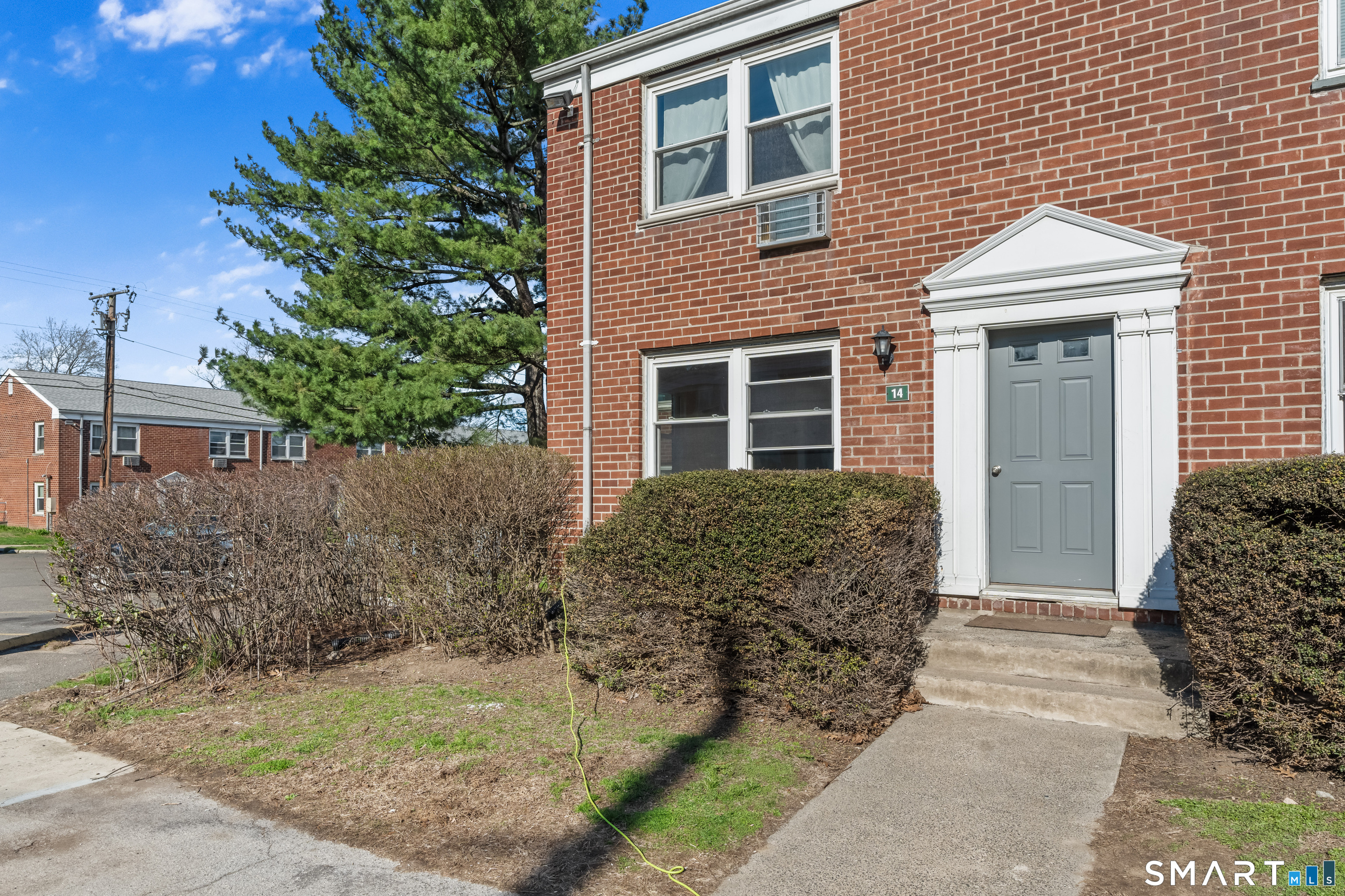 146 Blachley Road, Unit C Stamford, CT 06902 - Photo 30 of 44 a front view of a house with garden