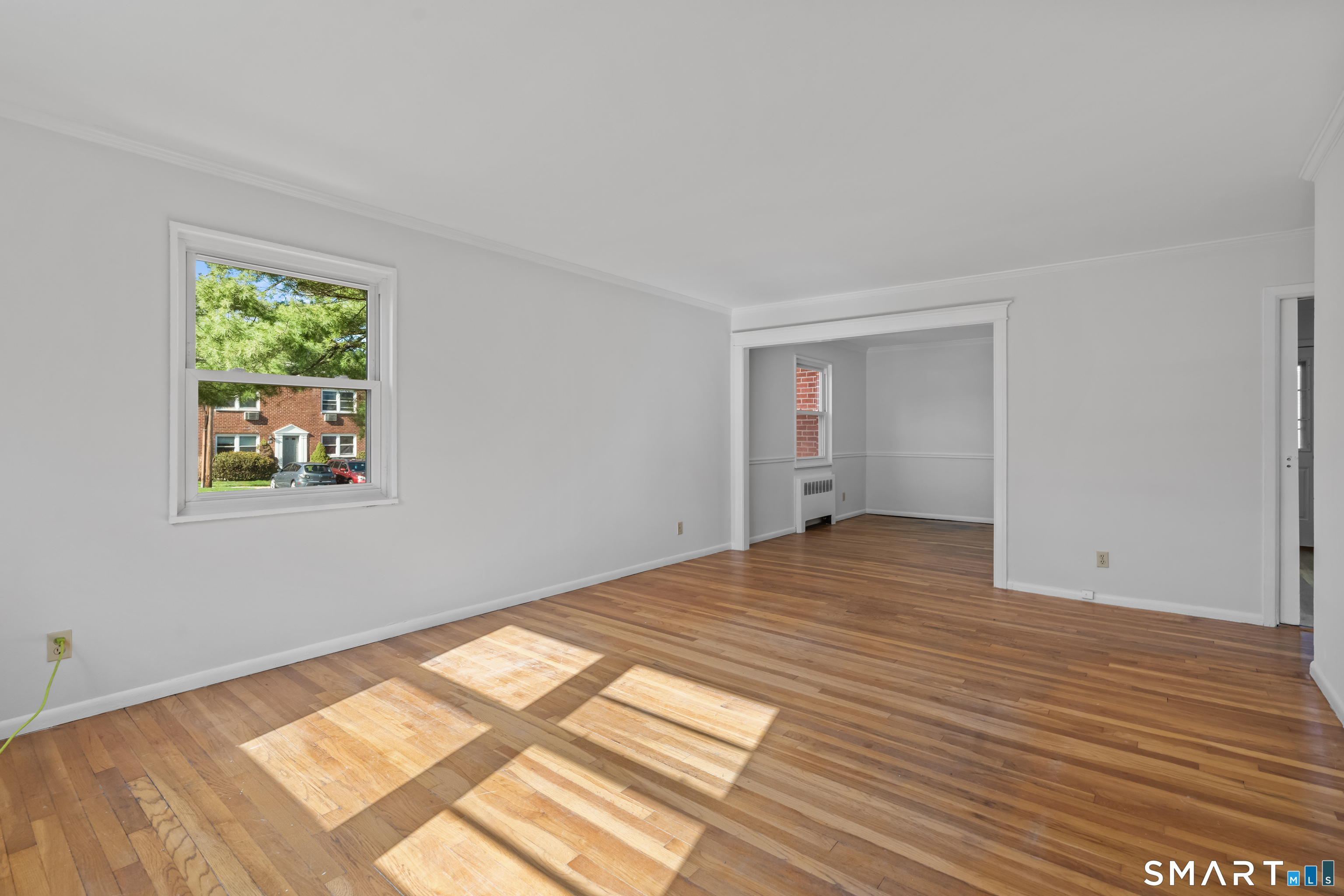 146 Blachley Road, Unit C Stamford, CT 06902 - Photo 6 of 44 a view of empty room with wooden floor and fan