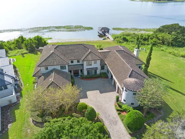 a front view of a brick house with a yard