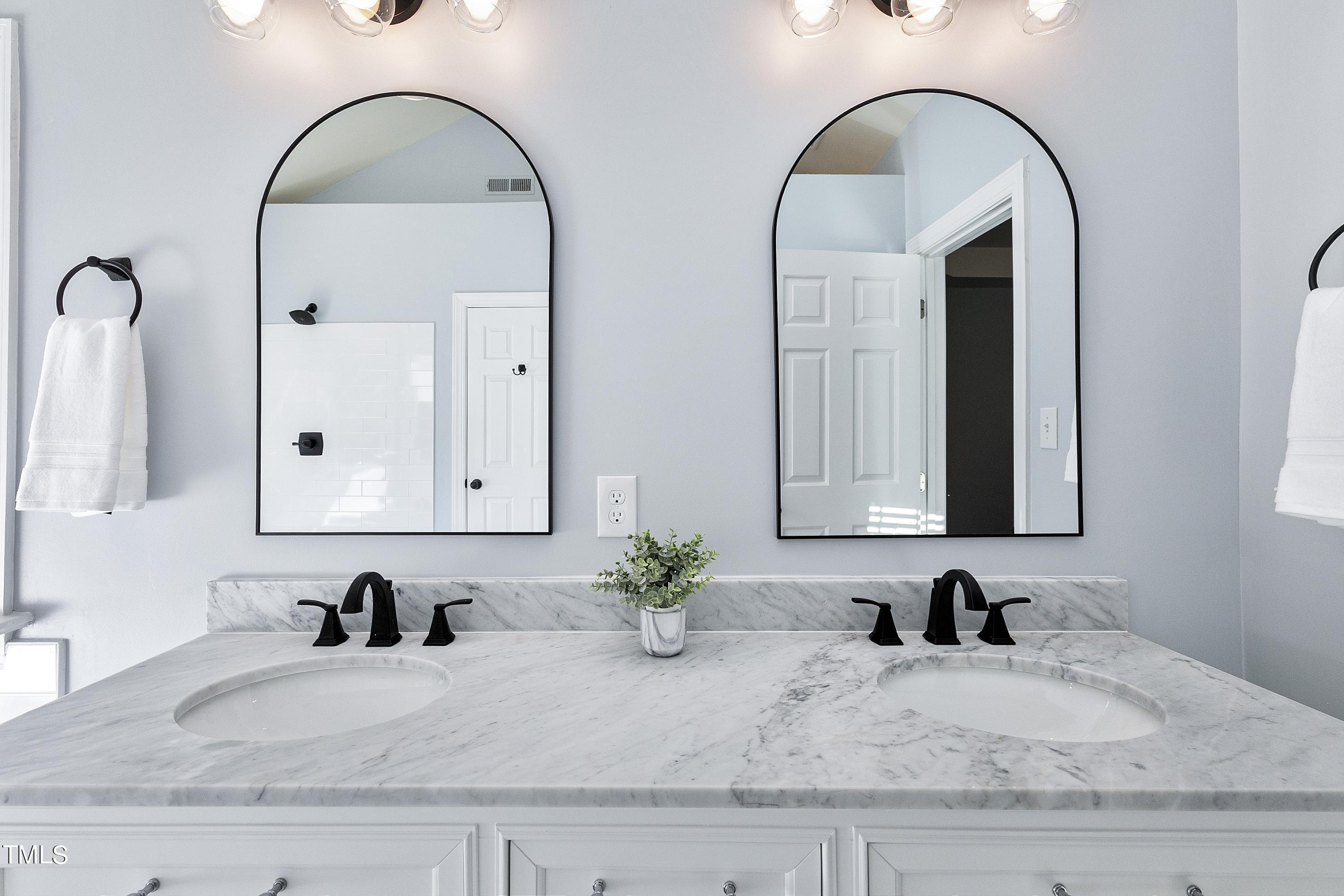 8928 Windjammer Drive Raleigh, NC 27615 - Photo 17 of 44 Beautifully remodeled primary ensuite with new tile walk-in shower, new tile flooring and new double vanity