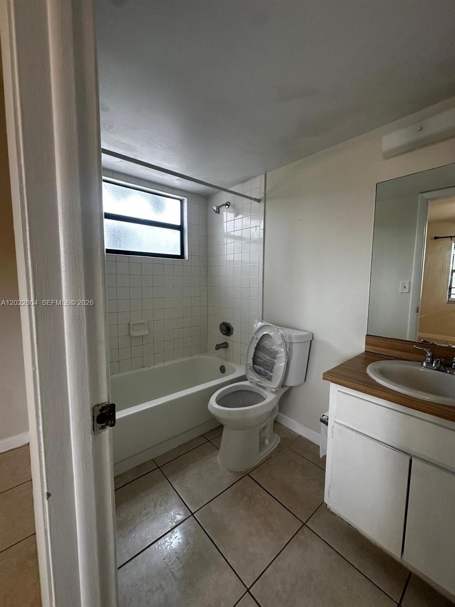 3400 Foxcroft Road, Unit 301 Miramar, FL 33025 - Photo 47 of 72 a bathroom with a toilet sink and mirror