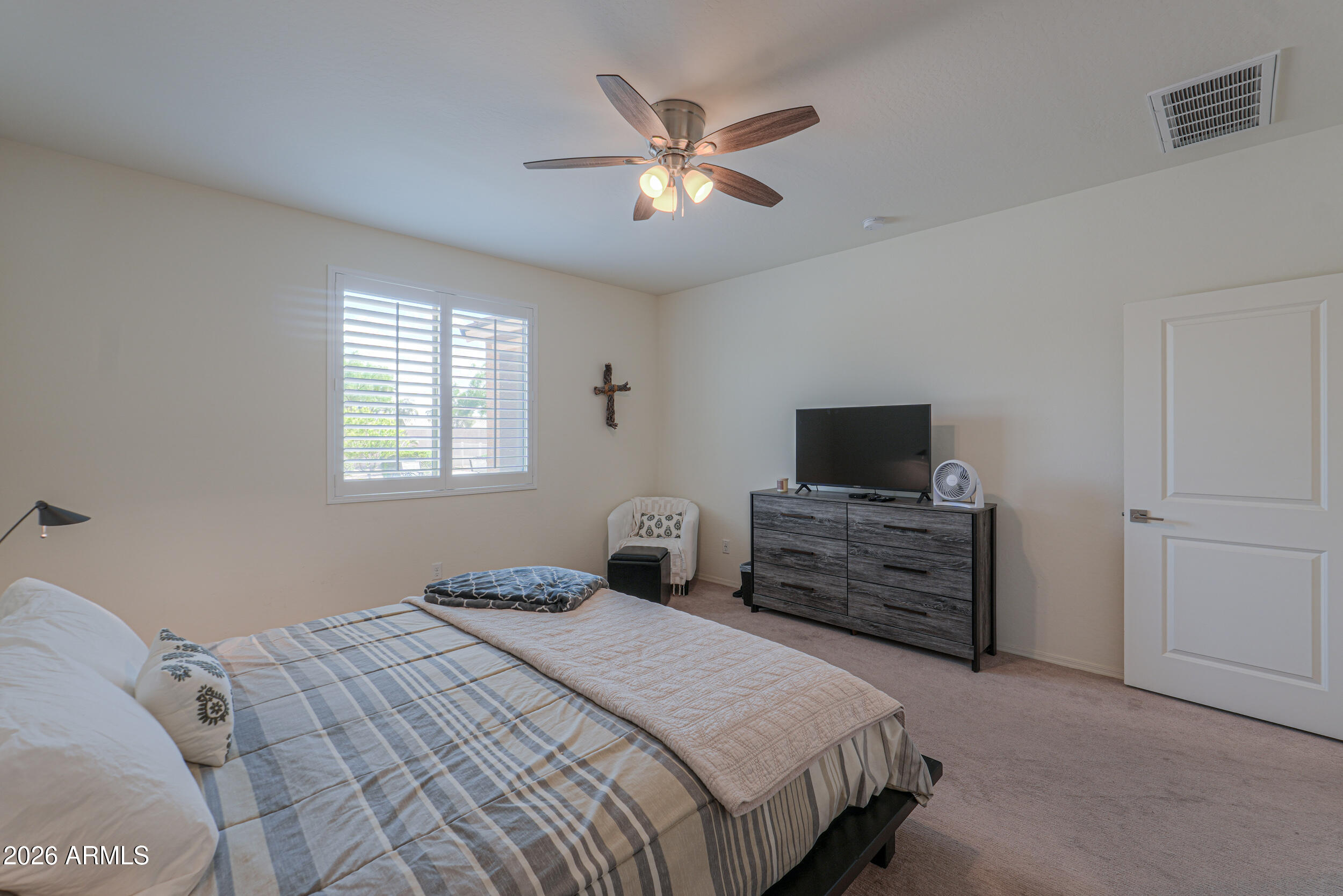 42085 West Cribbage Road Maricopa, AZ 85138 - Photo 22 of 35 a bedroom with a bed and a flat screen tv