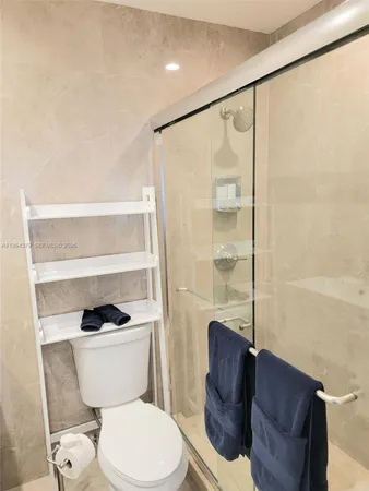 a bathroom with a toilet and a shower