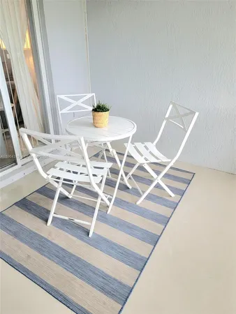 a view of a room with table and chairs