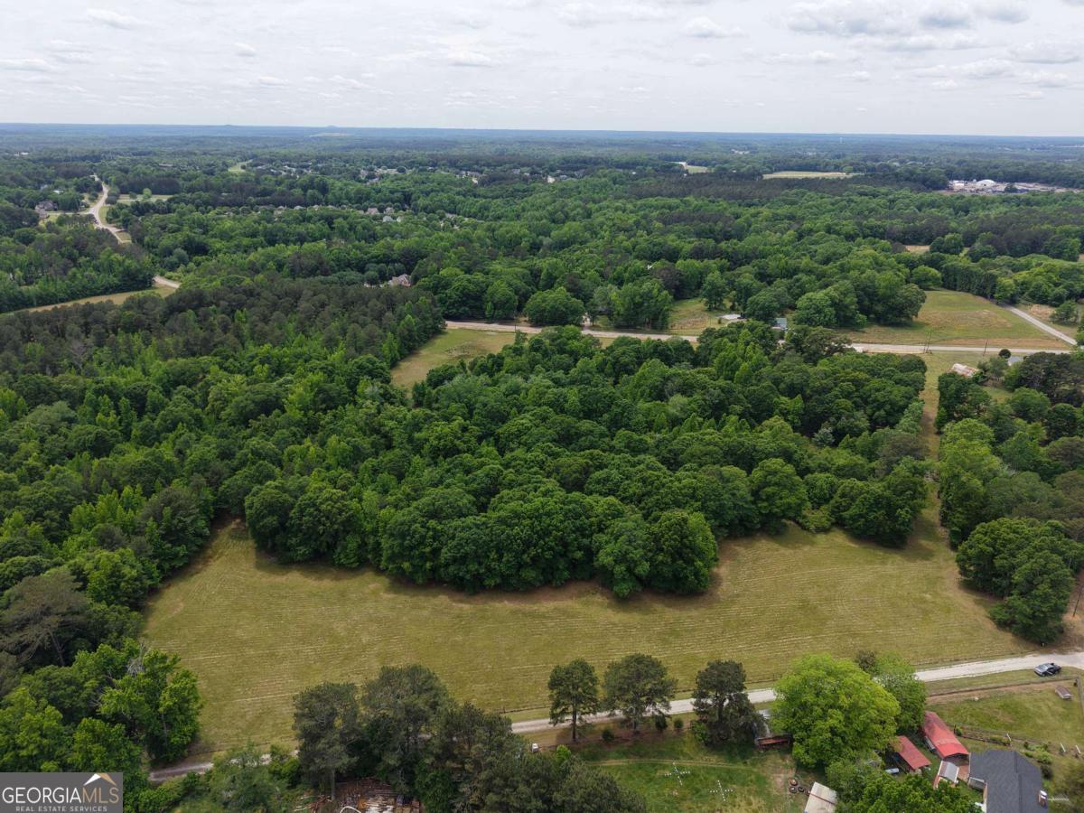 Tract 4 Mcnutts Creek Road Bogart, GA 30622 - Photo 5 of 6 an aerial view of green landscape with trees houses and mountain view