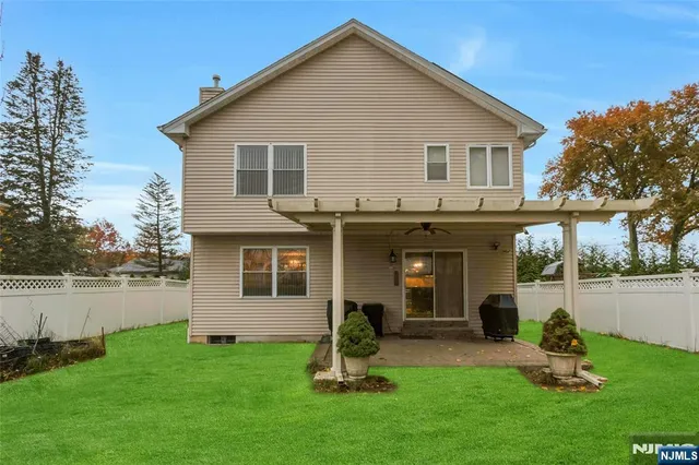 a front view of a house with a garden and plants