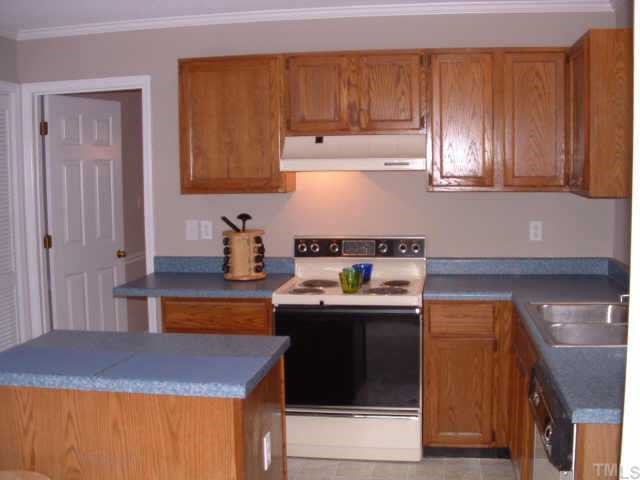 4641 Draper Road Raleigh, NC 27616 - Photo 5 of 9 a kitchen with stainless steel appliances granite countertop wooden cabinets a sink and dishwasher
